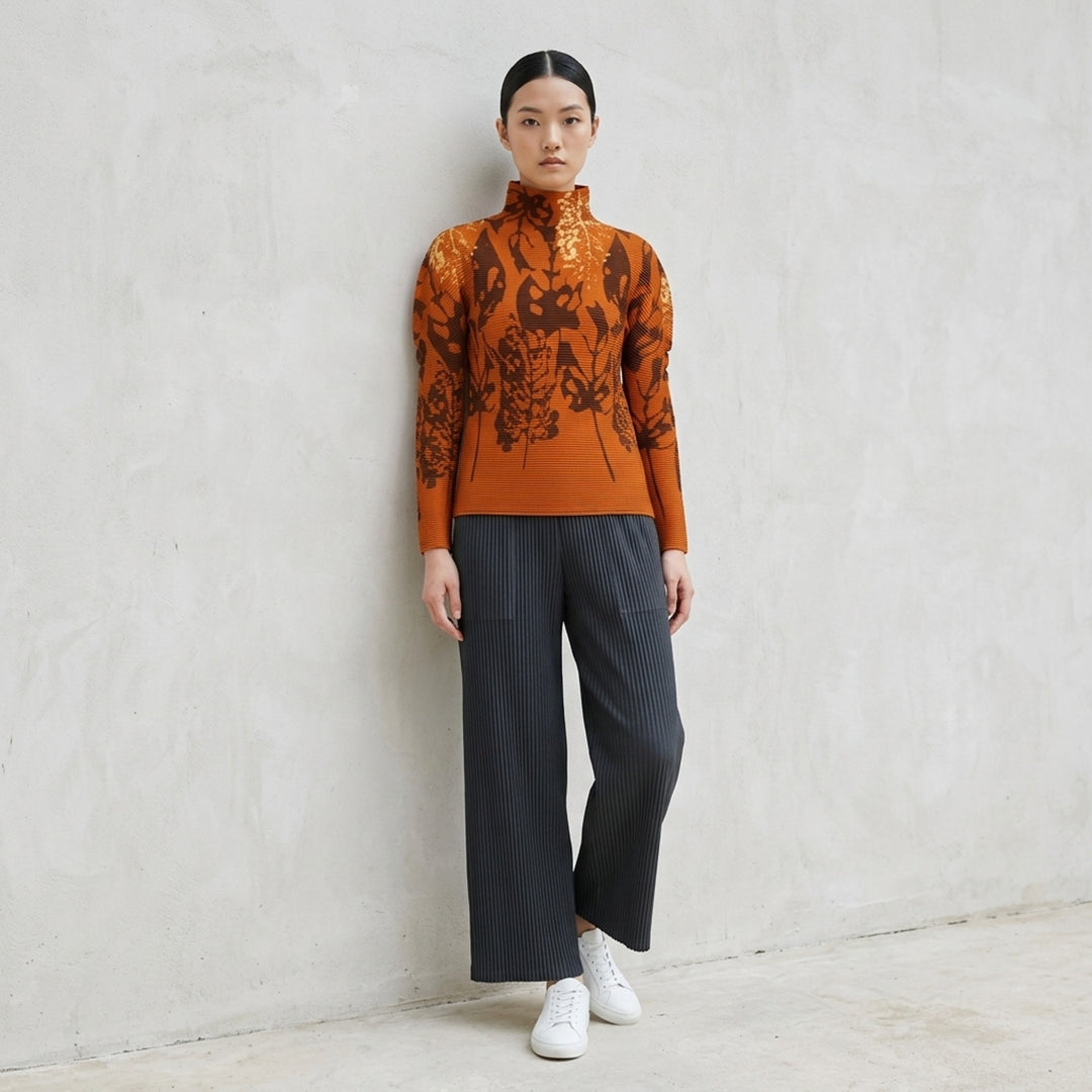 me Issey Miyake LEAF long sleeve high neck pleated top in amber orange with brown and pale gold botanical leaf print - lifestyle