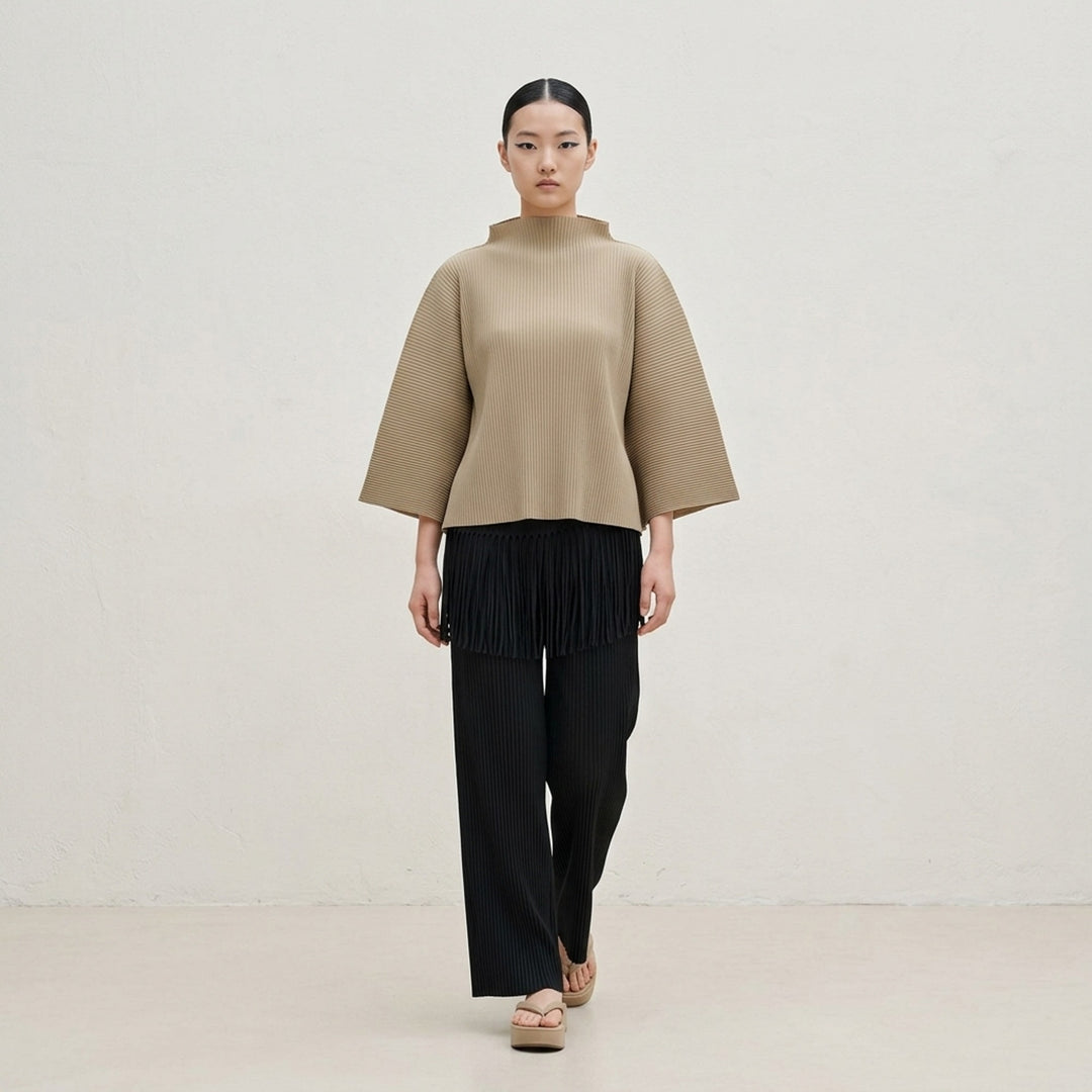 me Issey Miyake Leaf Pleats Pants in black — rear view showing wide-leg pleated silhouette with dramatic fringe trim at the hip yoke and elasticated waistband - lifestyle
