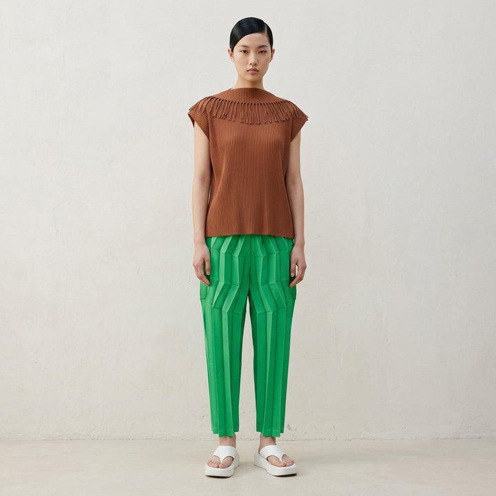 me Issey Miyake Leaf Pleats Top in black — back view showing ribbed pleated fabric with looped fringe trim across both shoulders and a boxy cap-sleeve silhouette - lifestyle