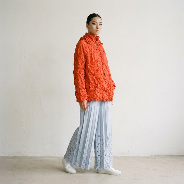me Issey Miyake Meringue Parka in black — oversized crinkled blouson with ruched hood, snap-button front, and drawstring hem and cuffs - lifestyle