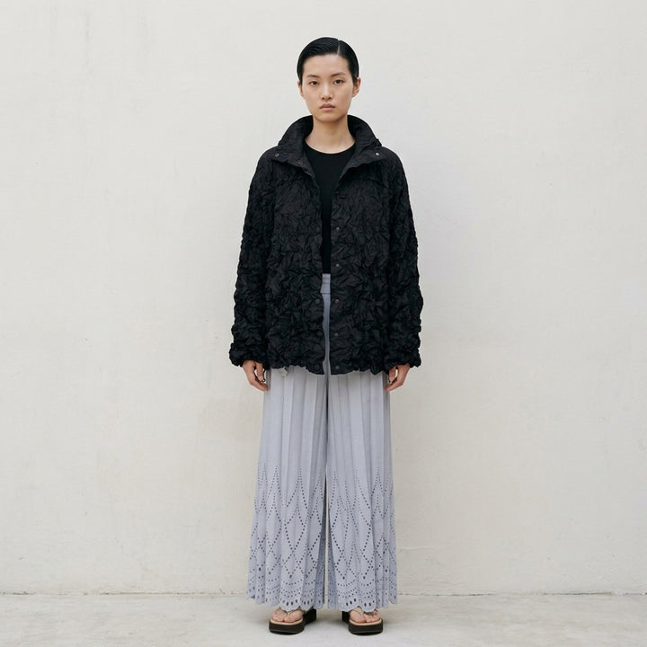 me Issey Miyake Meringue Parka in black — oversized crinkled blouson with ruched hood, snap-button front, and drawstring hem and cuffs - lifestyle