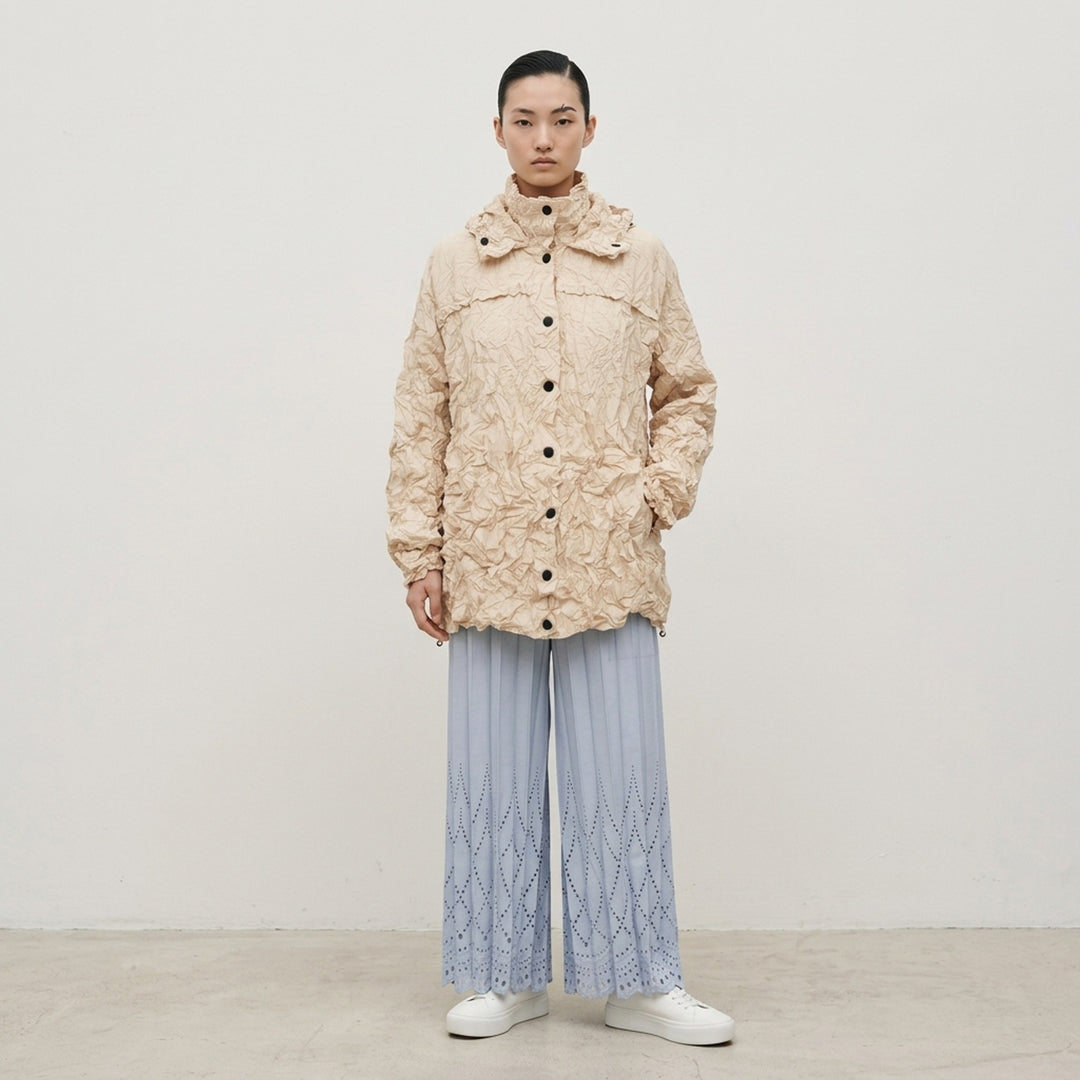 me Issey Miyake Meringue Parka in black — oversized crinkled blouson with ruched hood, snap-button front, and drawstring hem and cuffs - lifestyle