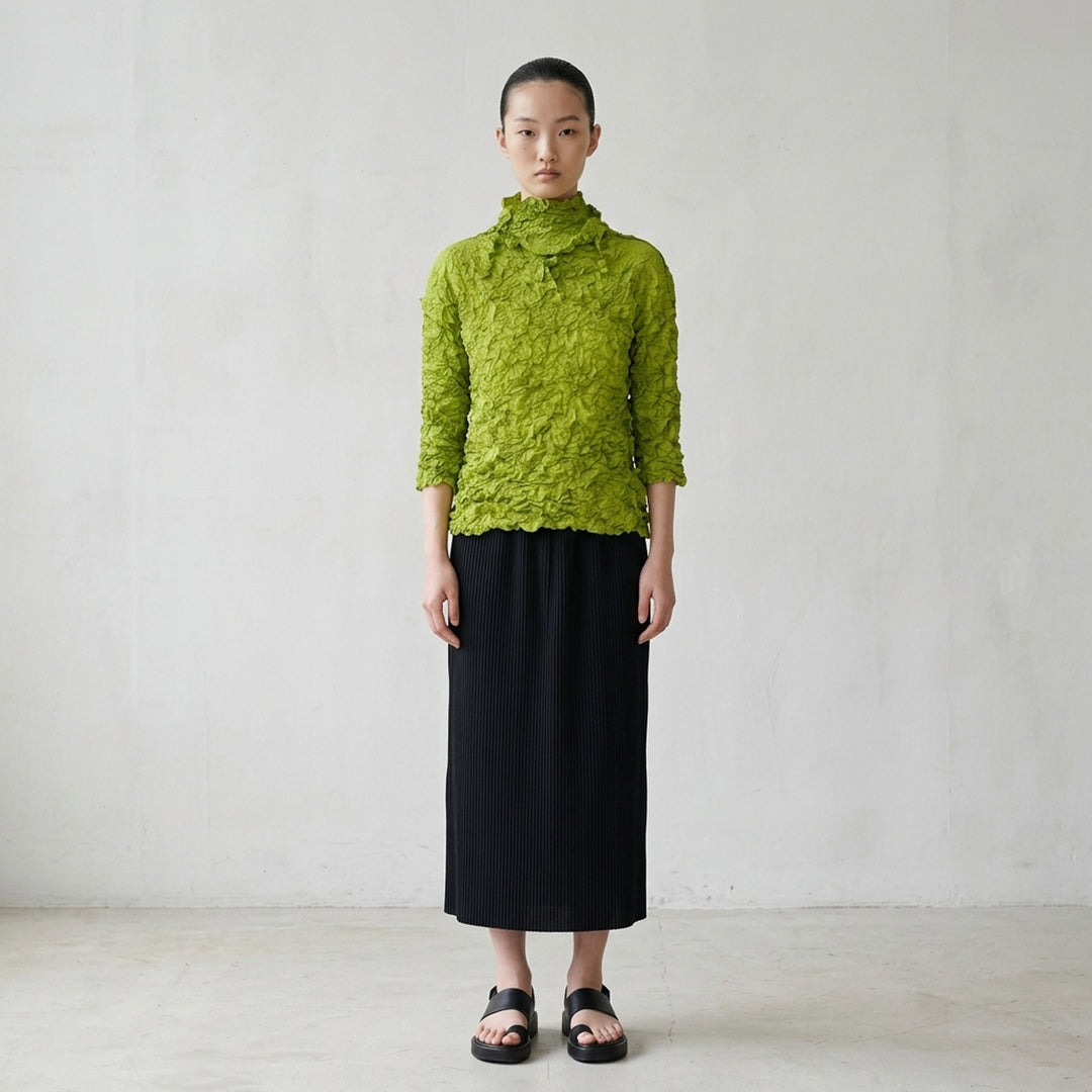 me Issey Miyake Meringue Top in black with allover crinkled texture, funnel neckline and short sleeves - lifestyle