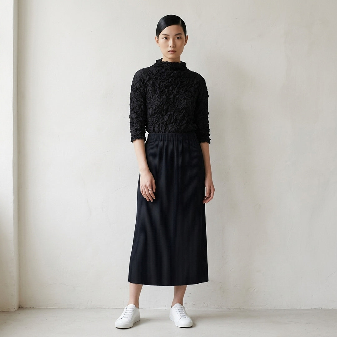 me Issey Miyake Meringue Top in black with allover crinkled texture, funnel neckline and short sleeves - lifestyle