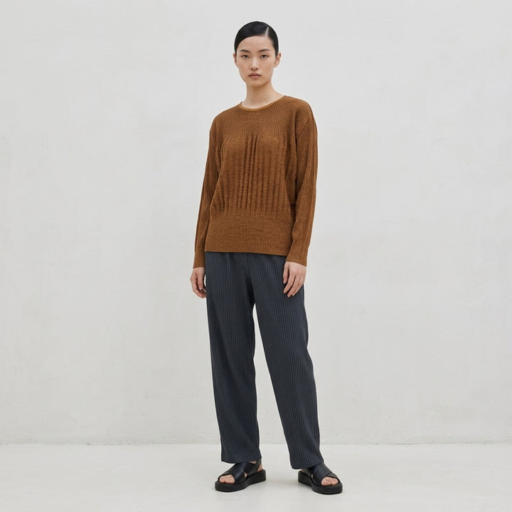 me Issey Miyake Mix Fine Knit Pleats black long-sleeve pleated top with banded hem, front view - lifestyle