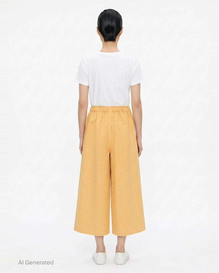 me Issey Miyake PINA CLOTH wide-leg pants in charcoal grey with a wrap-front panel, elasticated waist, and patch pockets - back
