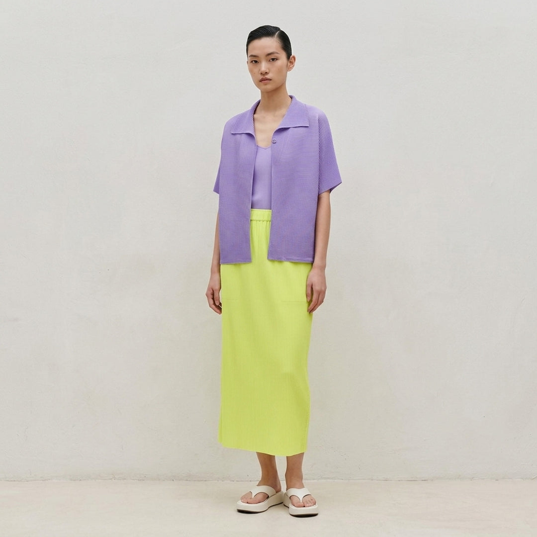 me Issey Miyake Square Stretch Pleats cardigan in black, featuring a boxy silhouette, spread collar, square micro-pleated texture, short sleeves, and single button front closure - lifestyle