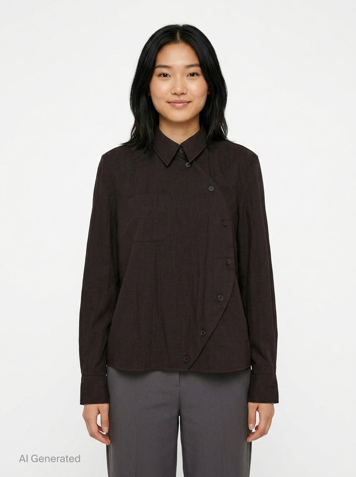 Melitta Baumeister Circle Shirt in black, featuring an asymmetric curved button placket, point collar, chest patch pocket, and structured long sleeves with wide cuffs - front