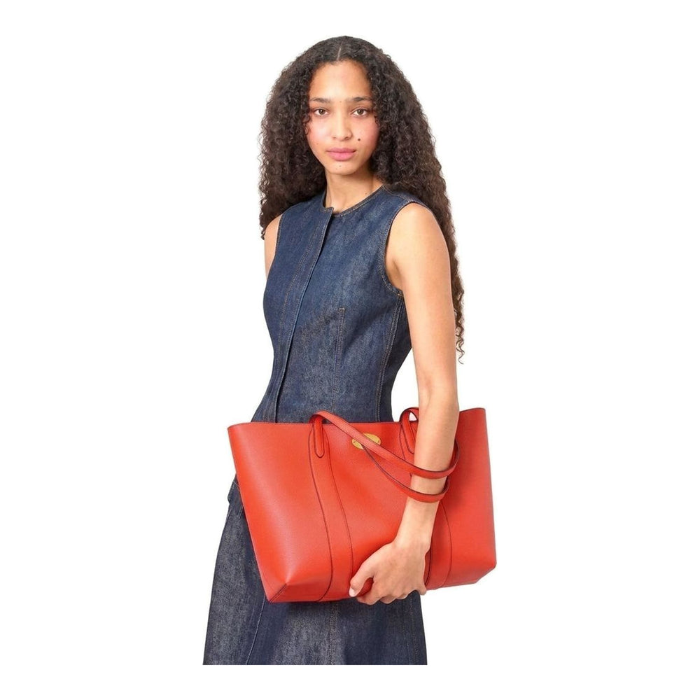 Mulberry Bayswater Small Tote in deep oxblood pebbled leather with twin flat shoulder straps and gold oval postman's lock hardware, front view on neutral background - packshot