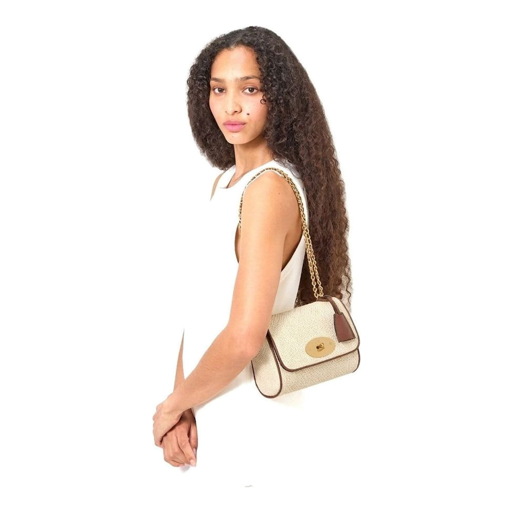 Mulberry Lily raffia shoulder bag in natural cream with tan leather trim, gold chain strap and oval gold Postman's Lock closure, front view - packshot