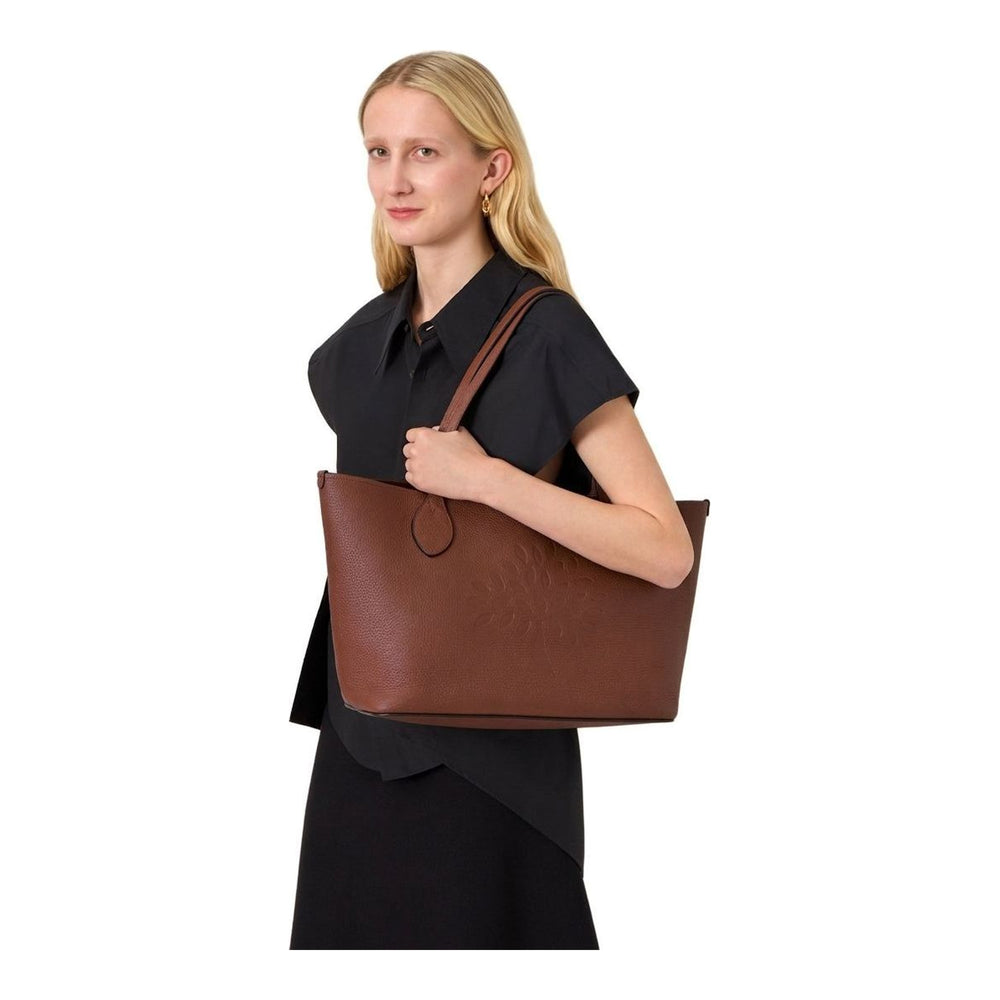 Mulberry Tree Tote in black heavy grain leather, featuring tonal cutwork Mulberry tree motif on the front panel and twin flat shoulder straps with teardrop finials - packshot