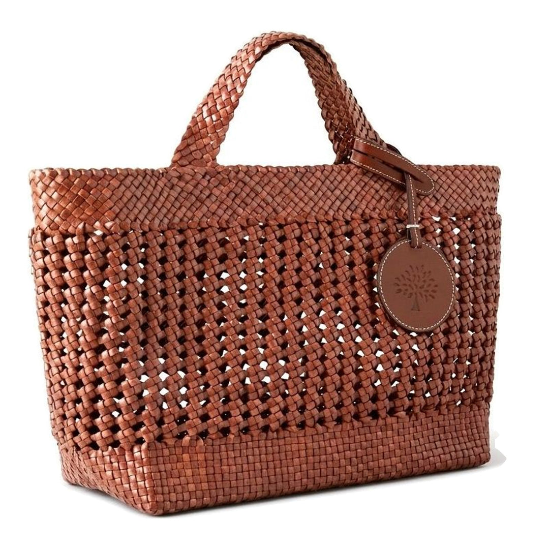 Mulberry Small Woven Leather Tote in tan, featuring an open lattice weave body, braided leather handles, and an embossed circular tree logo charm - packshot
