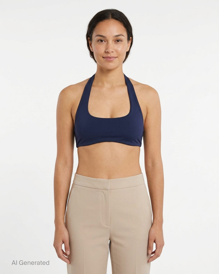 Navy halter-neck bralette from Nike X Jacquemus with a scoop front neckline and open back, shown flat against a white background - front