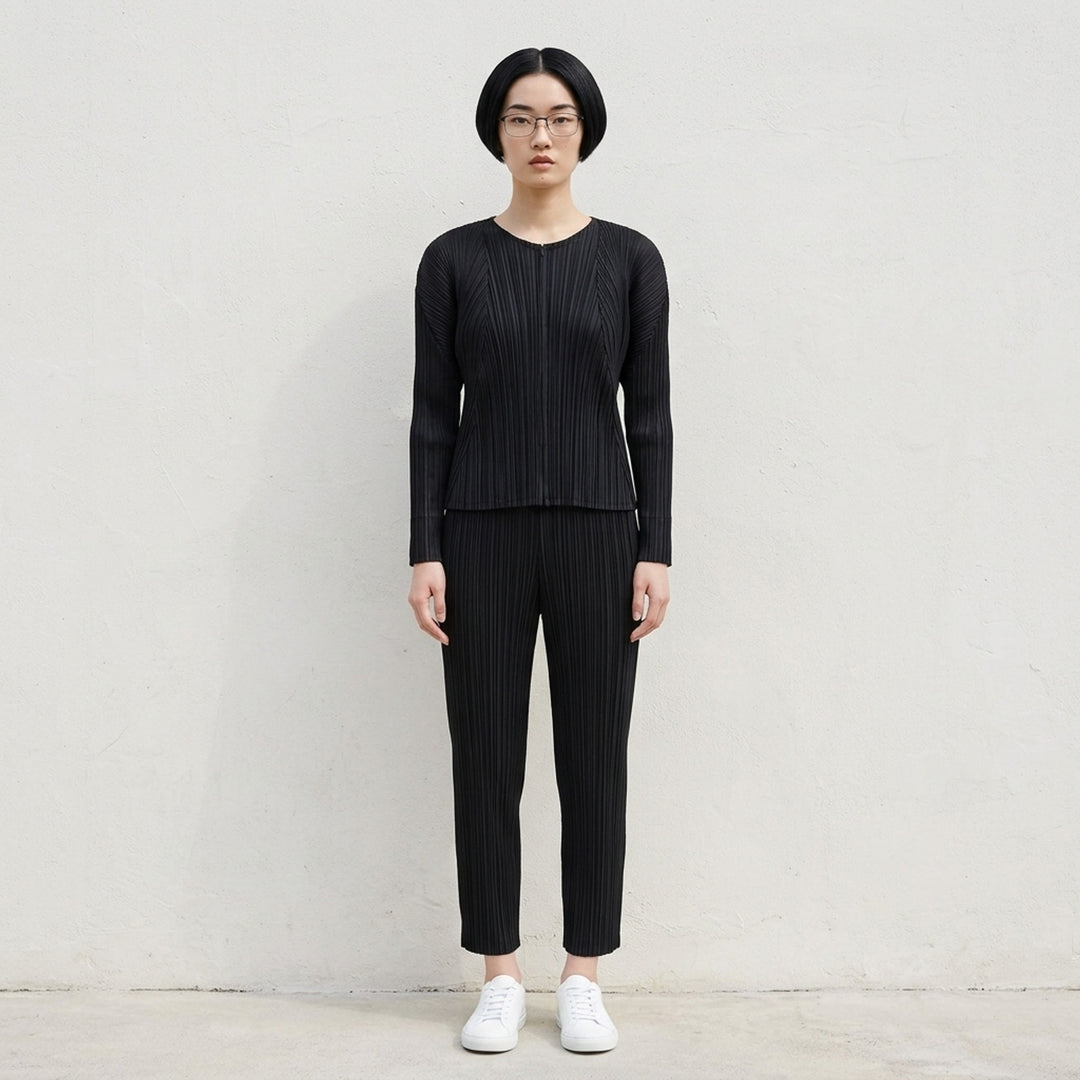Back view of a grey pleated cardigan by Pleats Please Issey Miyake with fanning pleats and long dolman sleeves - lifestyle