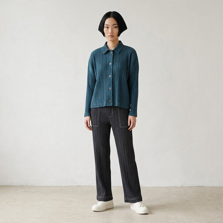 Pleats Please Issey Miyake Cotton Denim blouson in indigo blue with pleated texture, pointed collar, button front and darker shoulder panels - lifestyle