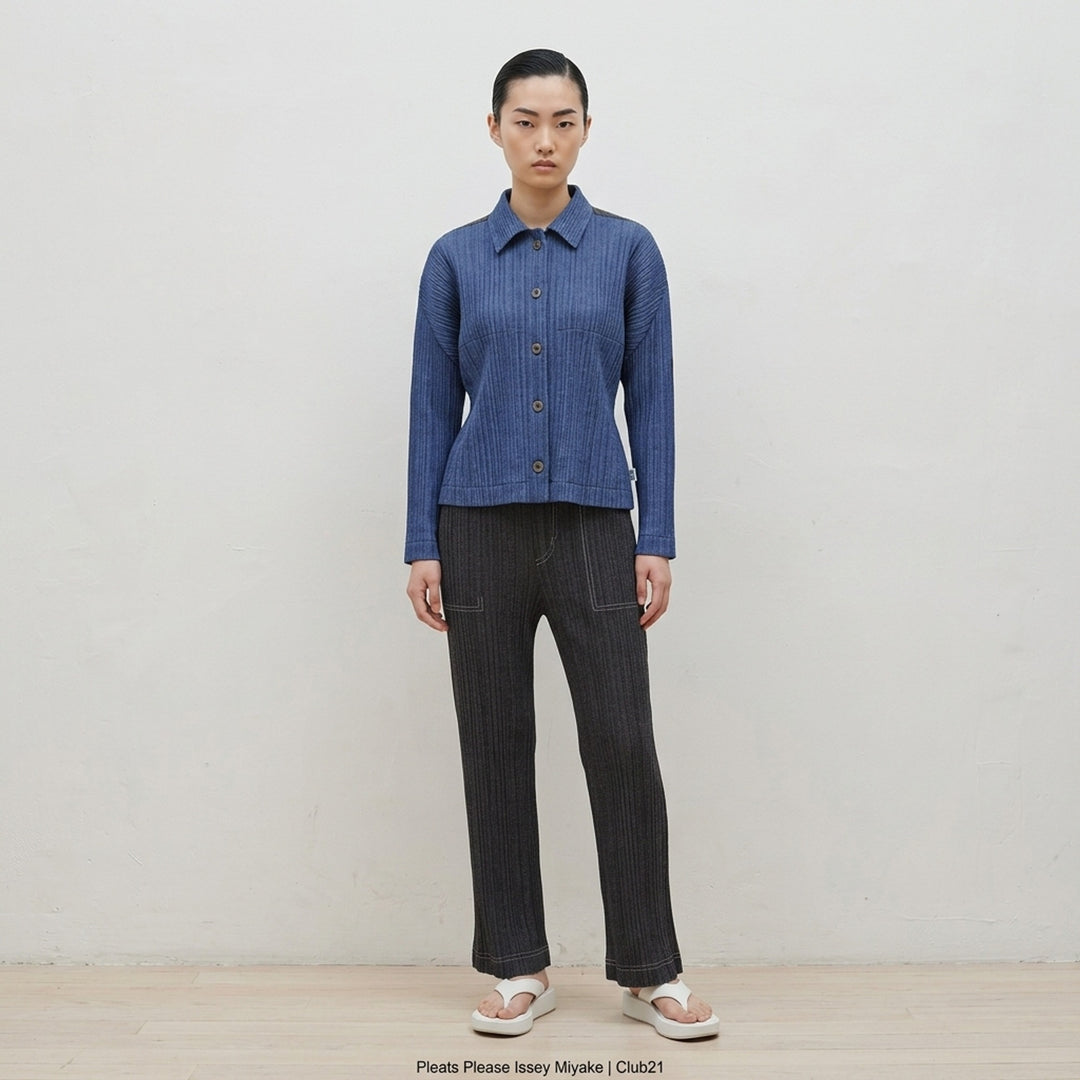 Pleats Please Issey Miyake Cotton Denim blouson in indigo blue with pleated texture, pointed collar, button front and darker shoulder panels - lifestyle