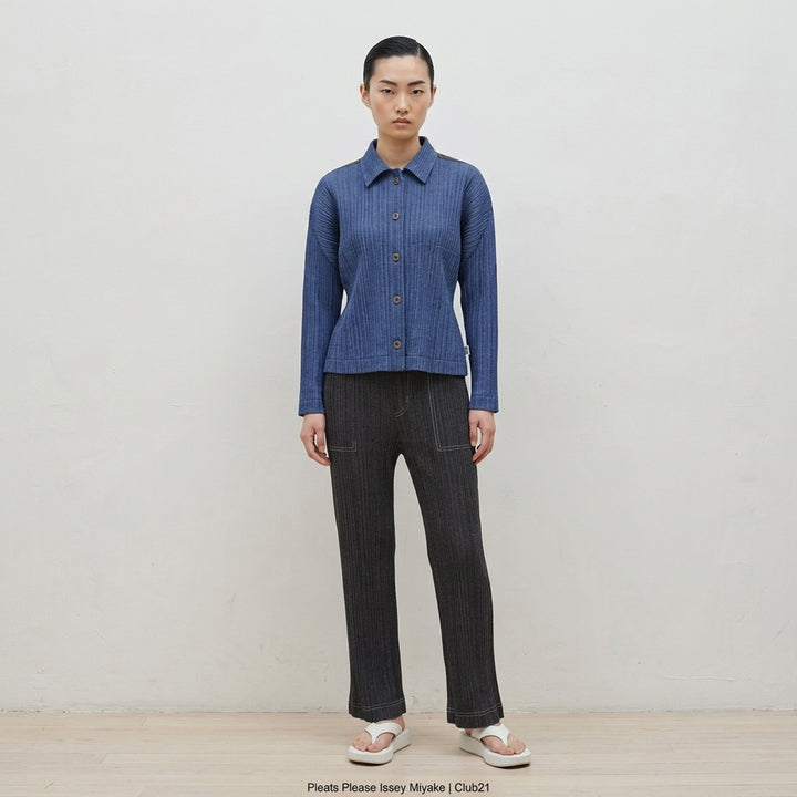 Pleats Please Issey Miyake Cotton Denim blouson in indigo blue with pleated texture, pointed collar, button front and darker shoulder panels - lifestyle
