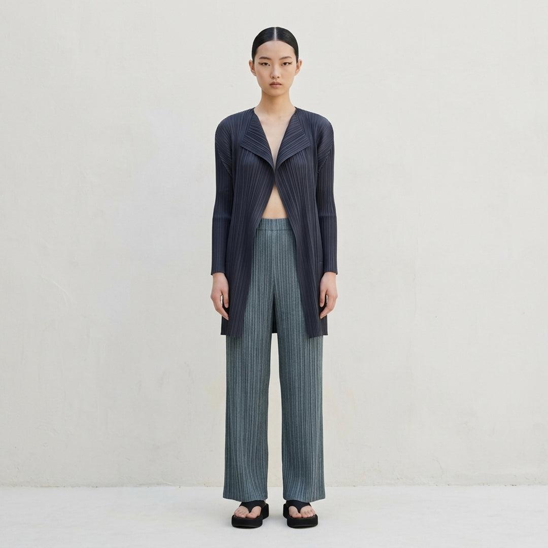 Pleats Please Issey Miyake Cotton Denim pleated wide-leg pants in textured teal-green, front view - lifestyle