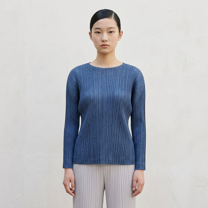 Pleats Please Issey Miyake long-sleeve pleated crew-neck top in deep teal, shown from the front - lifestyle