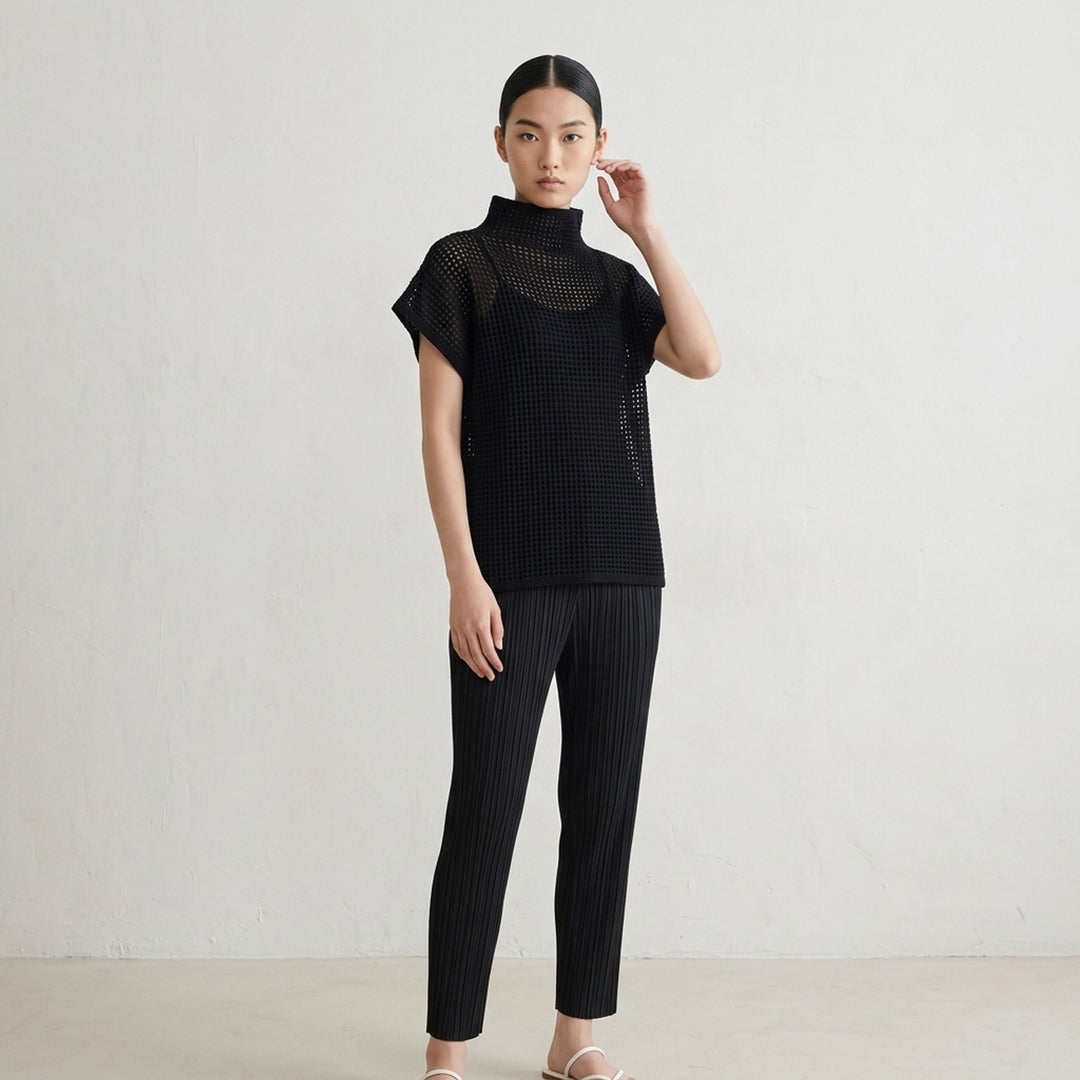 Black open-mesh dot knit top with funnel neck and cap sleeves by Pleats Please Issey Miyake - lifestyle