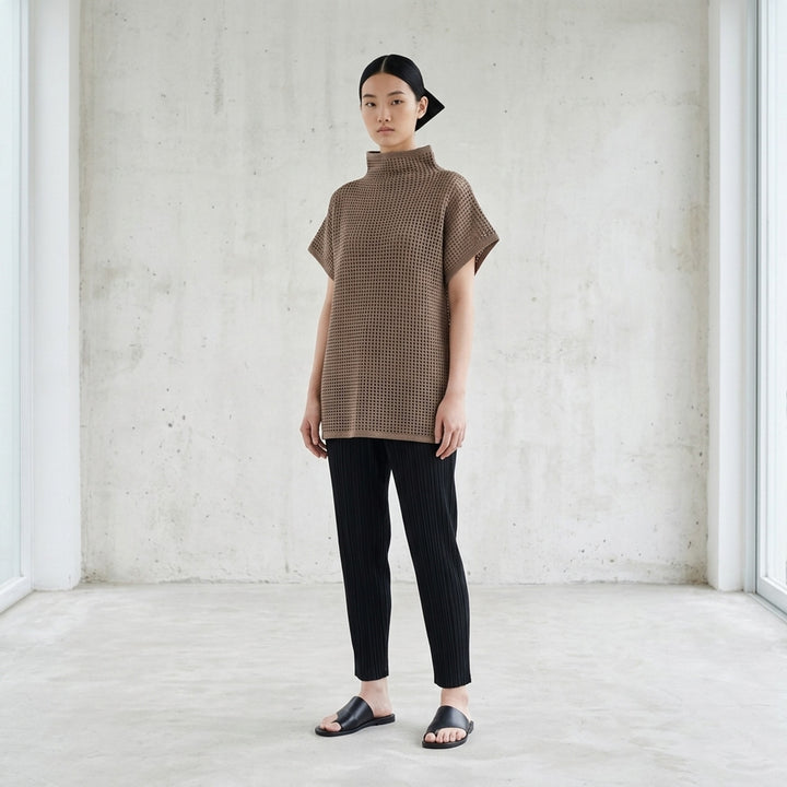 Black open-mesh dot knit top with funnel neck and cap sleeves by Pleats Please Issey Miyake - lifestyle