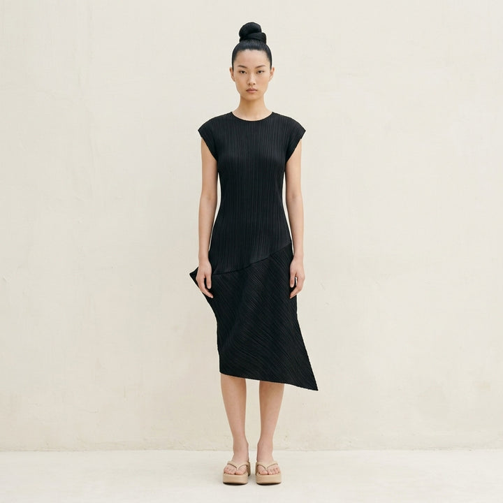 Black sleeveless pleated midi dress by Pleats Please Issey Miyake with vertical pleated bodice and asymmetric diagonal-pleated skirt - lifestyle
