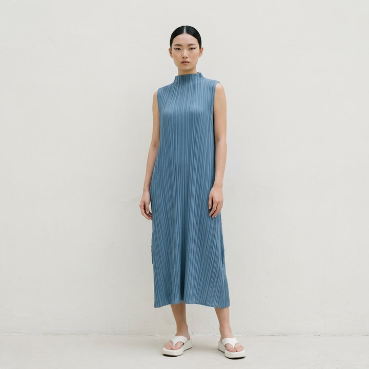 Pleats Please Issey Miyake Mellow Pleats sleeveless midi dress in steel blue with all-over permanent pleating and mock turtleneck collar, flat lay on white background - lifestyle