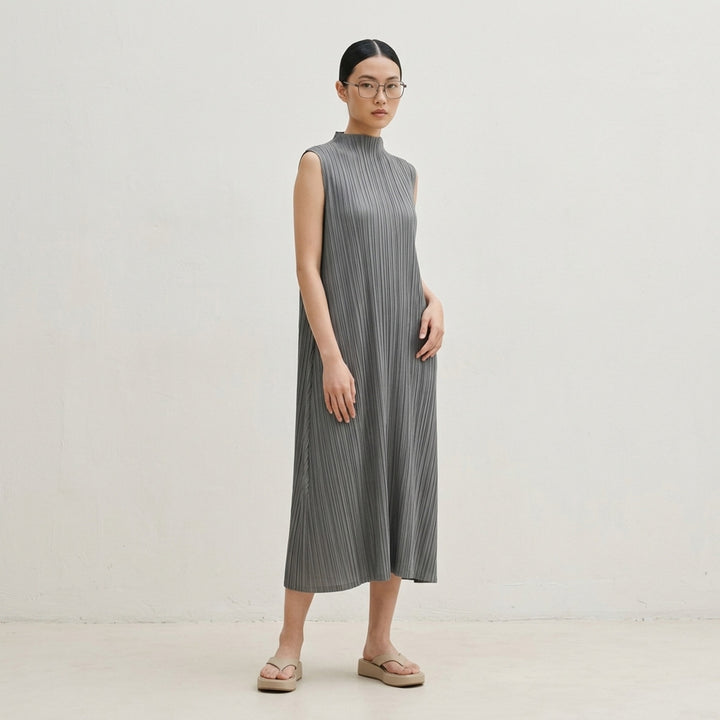 Pleats Please Issey Miyake Mellow Pleats sleeveless midi dress in steel blue with all-over permanent pleating and mock turtleneck collar, flat lay on white background - lifestyle