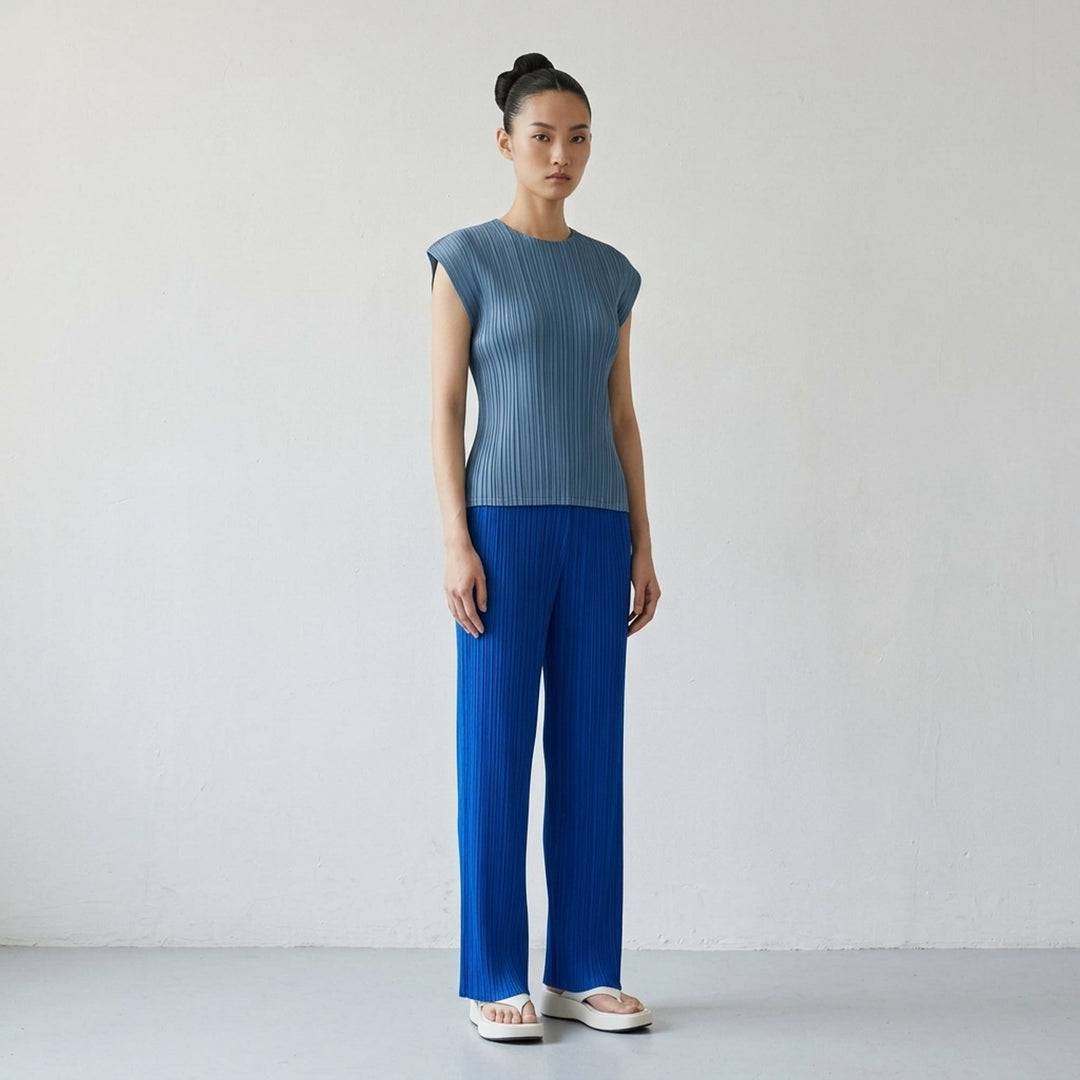 Pleats Please Issey Miyake Mellow Pleats cap-sleeve top in steel blue with all-over vertical plissé pleating and a round neckline - lifestyle