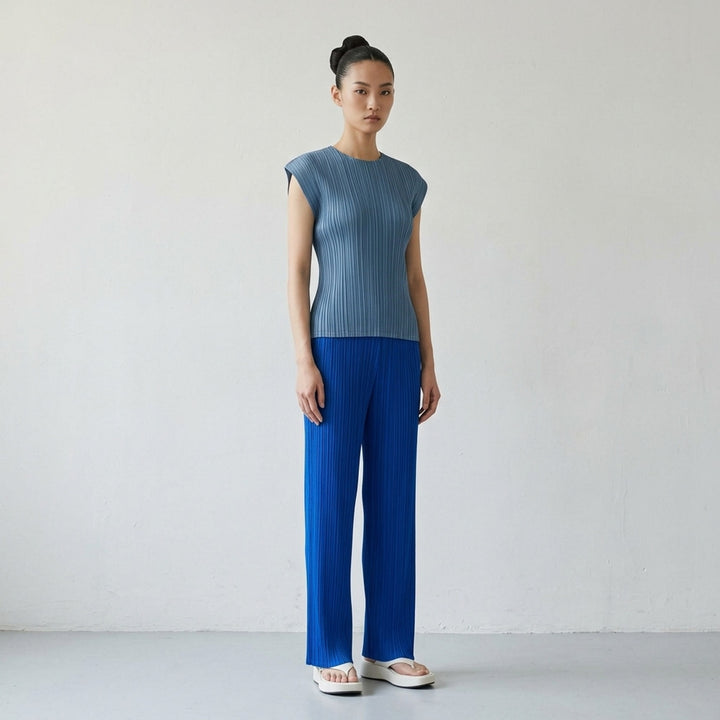 Pleats Please Issey Miyake Mellow Pleats cap-sleeve top in steel blue with all-over vertical plissé pleating and a round neckline - lifestyle