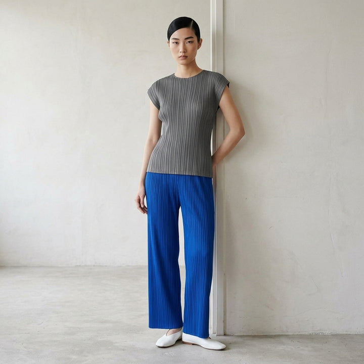 Pleats Please Issey Miyake Mellow Pleats cap-sleeve top in steel blue with all-over vertical plissé pleating and a round neckline - lifestyle