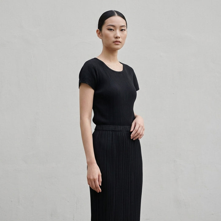 Pleats Please Issey Miyake Mist Basics Round Neck Top in black, featuring signature fine vertical pleating, a scoop neckline, and short cap sleeves with lettuce-edge trim - lifestyle