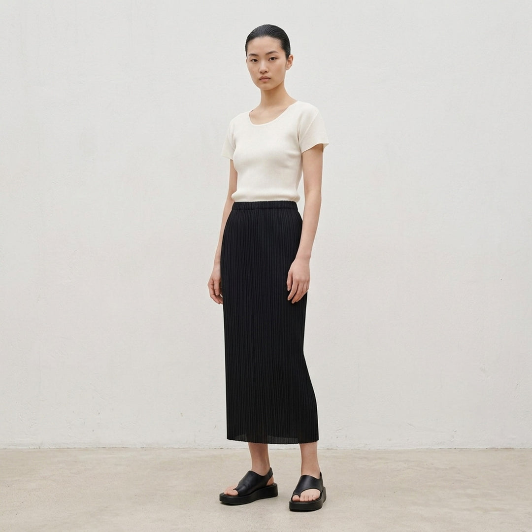 Pleats Please Issey Miyake Mist Basics Round Neck Top in black, featuring signature fine vertical pleating, a scoop neckline, and short cap sleeves with lettuce-edge trim - lifestyle