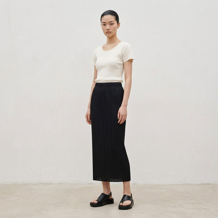 Pleats Please Issey Miyake Mist Basics Round Neck Top in black, featuring signature fine vertical pleating, a scoop neckline, and short cap sleeves with lettuce-edge trim - lifestyle