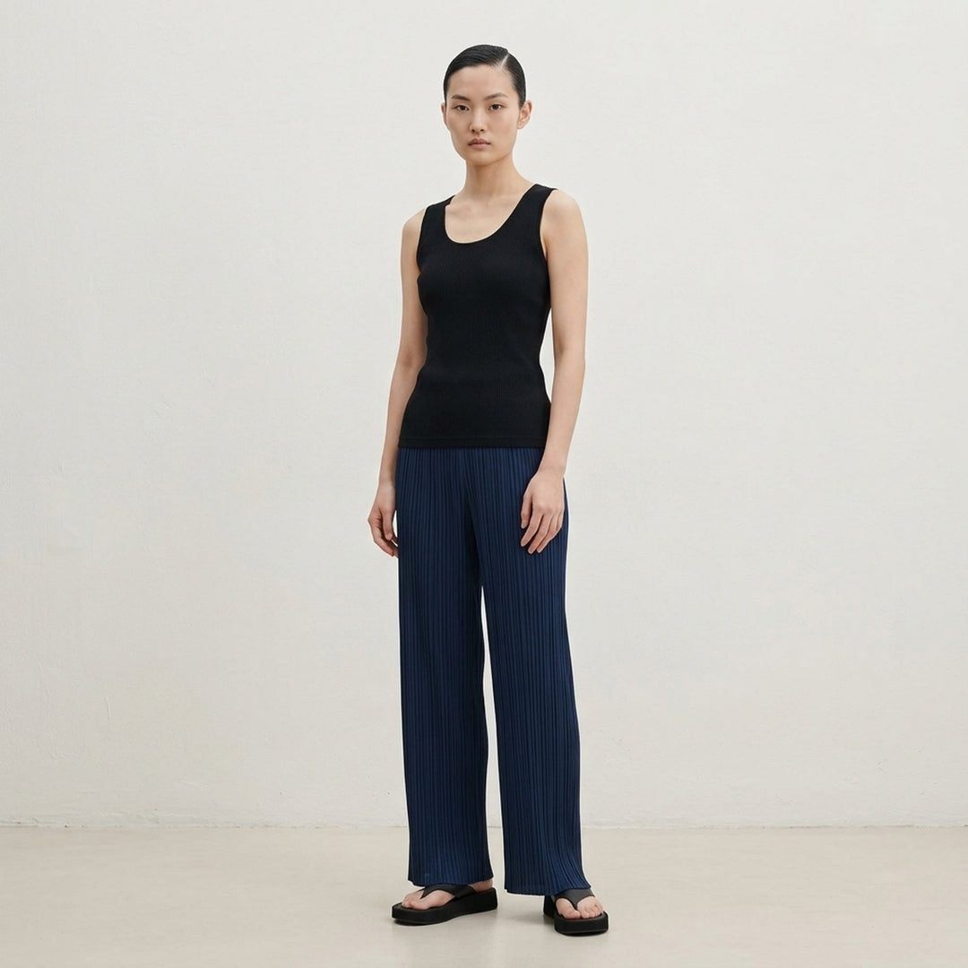 Pleats Please Issey Miyake Mist Basics Tank Top in black, featuring fine vertical pleating and a scoop neckline, sleeveless silhouette on a white background - lifestyle