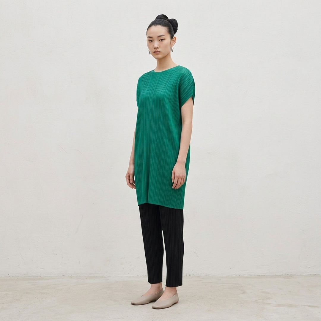Pleats Please Issey Miyake Monthly Colors July Dress in vibrant teal, featuring signature micro-pleating throughout and a relaxed cocoon silhouette with cap sleeves - lifestyle