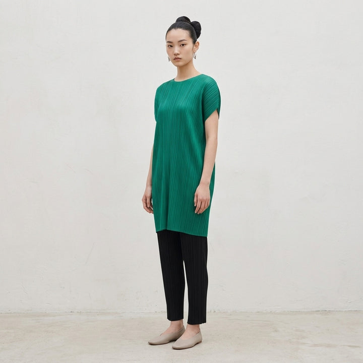 Pleats Please Issey Miyake Monthly Colors July Dress in vibrant teal, featuring signature micro-pleating throughout and a relaxed cocoon silhouette with cap sleeves - lifestyle