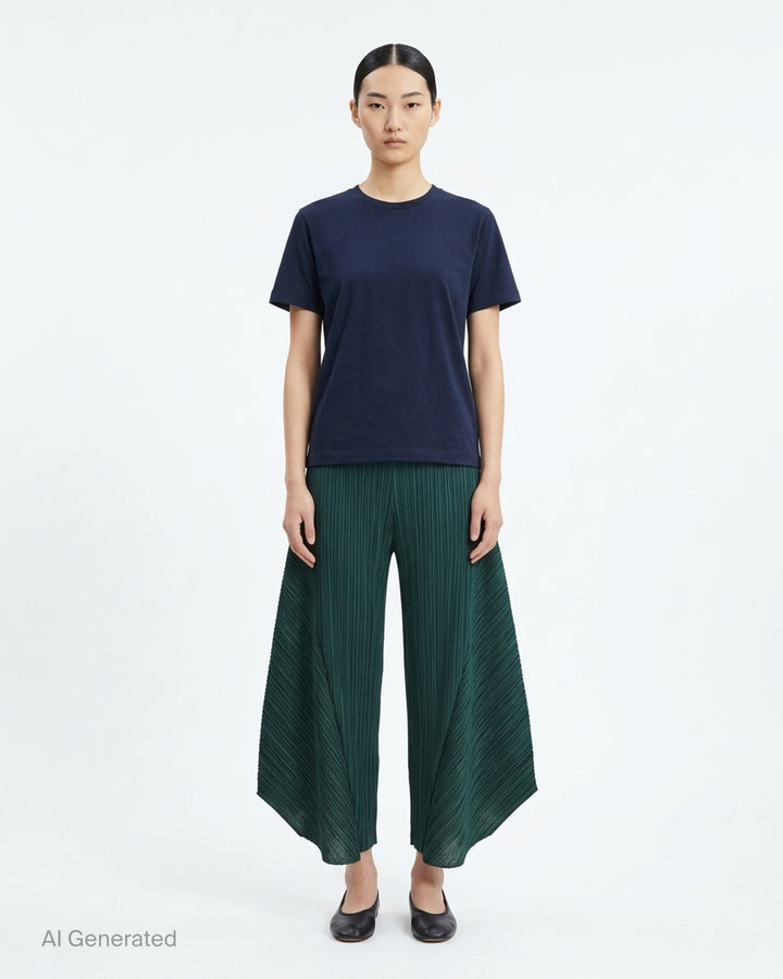 Pleats Please Issey Miyake Monthly Colors October pleated flared pants in deep green with sculpted side panels and elasticated waist - front