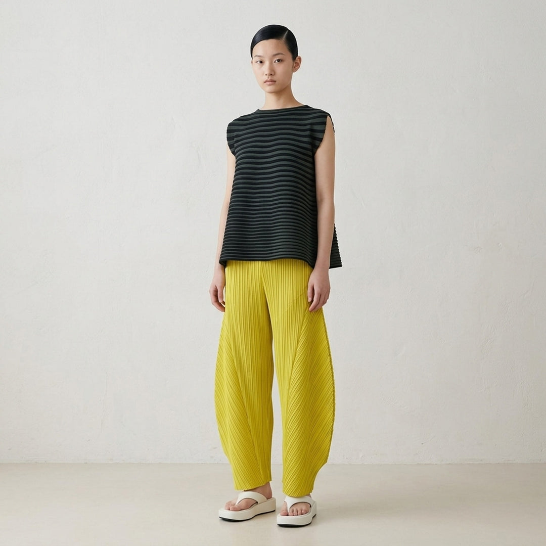 Pleats Please Issey Miyake Monthly Colors October pleated flared pants in deep green with sculpted side panels and elasticated waist - lifestyle