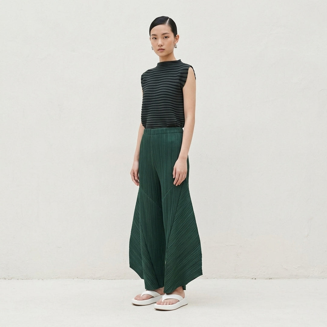 Pleats Please Issey Miyake Monthly Colors October pleated flared pants in deep green with sculpted side panels and elasticated waist - lifestyle