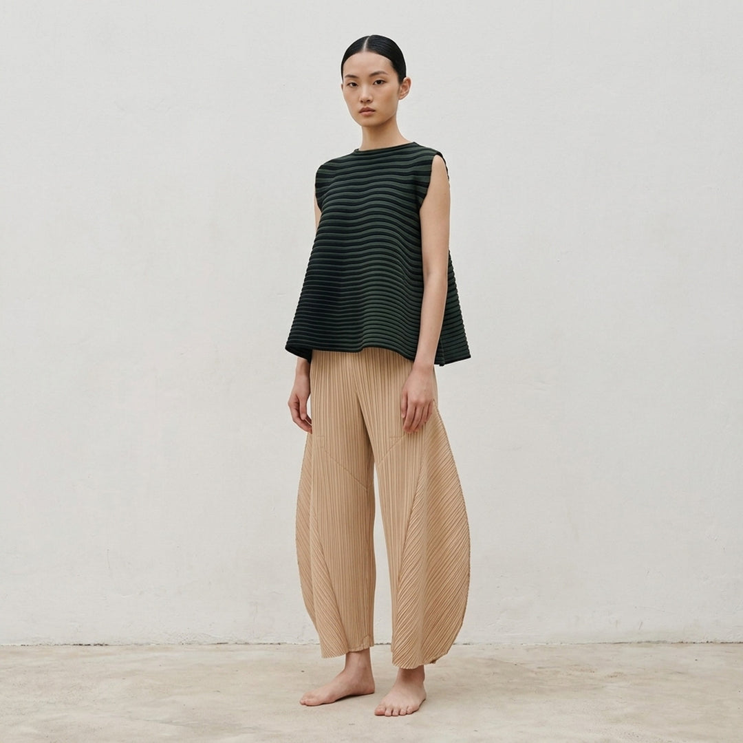 Pleats Please Issey Miyake Monthly Colors October pleated flared pants in deep green with sculpted side panels and elasticated waist - lifestyle