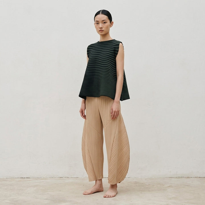 Pleats Please Issey Miyake Monthly Colors October pleated flared pants in deep green with sculpted side panels and elasticated waist - lifestyle