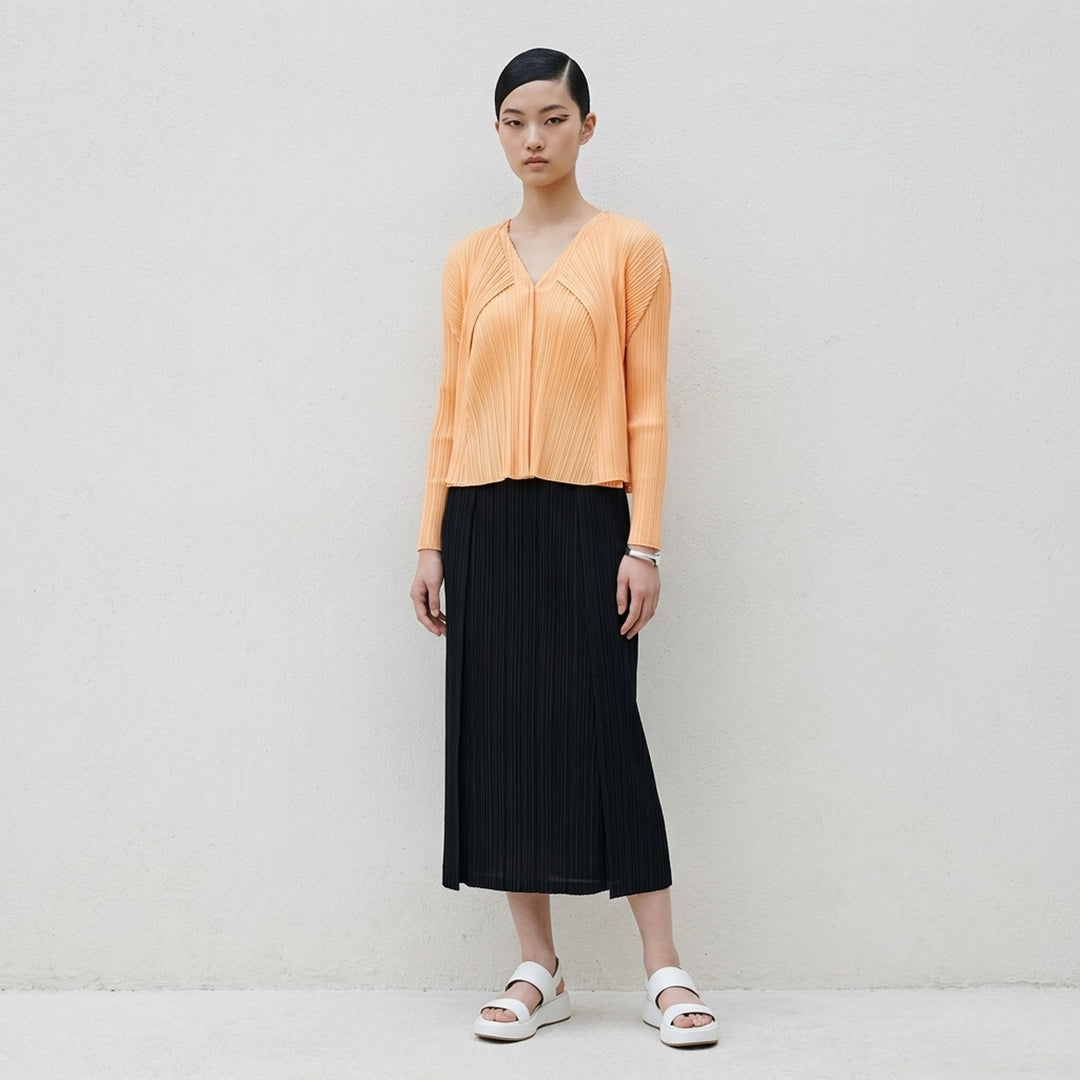 Pleats Please Issey Miyake Monthly Colors September black pleated open-front cardigan, back view, featuring radiating fan pleats from the yoke and long sleeves - lifestyle