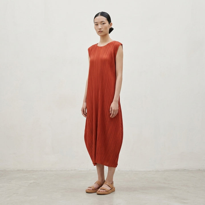 Pleats Please Issey Miyake Monthly Colors September sleeveless black micro-pleated dress with draped balloon hem, front view on white background - lifestyle