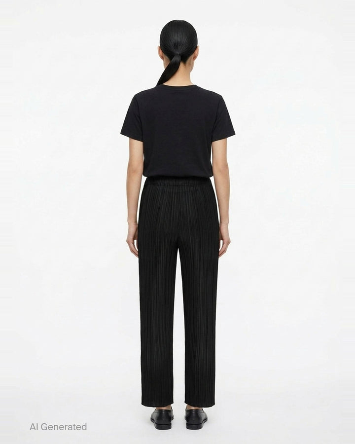Pleats Please Issey Miyake Monthly Colors September wide-leg pants in black, featuring fine vertical micro-pleating and an elasticated waistband, displayed flat against a white background - back