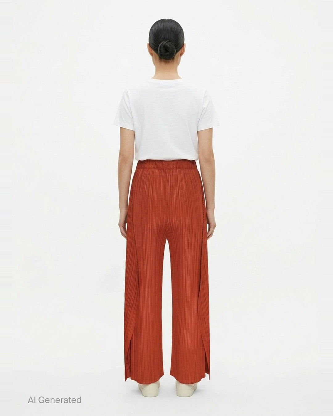 Pleats Please Issey Miyake Monthly Colors September wide-leg pants in black, featuring fine vertical micro-pleating and an elasticated waistband, displayed flat against a white background - back