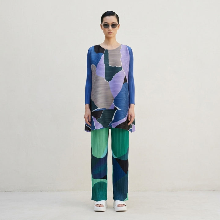 Pleats Please Issey Miyake Orbit wide-leg pleated pants with abstract green, teal, navy and black colour-block print - lifestyle