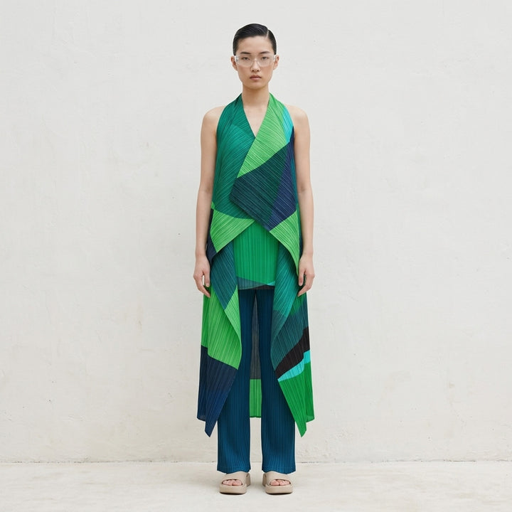 Pleats Please Issey Miyake Orbit halter-neck pleated vest with draped asymmetric panels in green, teal, navy and black geometric colour-blocking - lifestyle