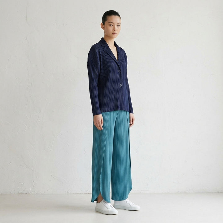 Pleats Please Issey Miyake Pleats Jacket in charcoal, featuring all-over micro-pleating, notched lapel, two-button closure, and long sleeves, displayed flat on a white background - lifestyle