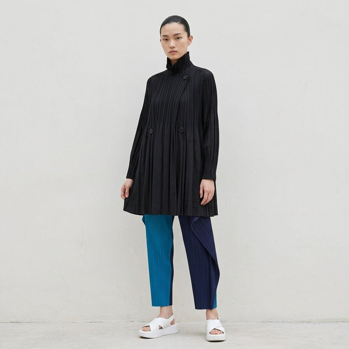 Pleats Please Issey Miyake Smooth Coat in black with fine vertical pleats, spread collar and double-breasted button fastening - lifestyle